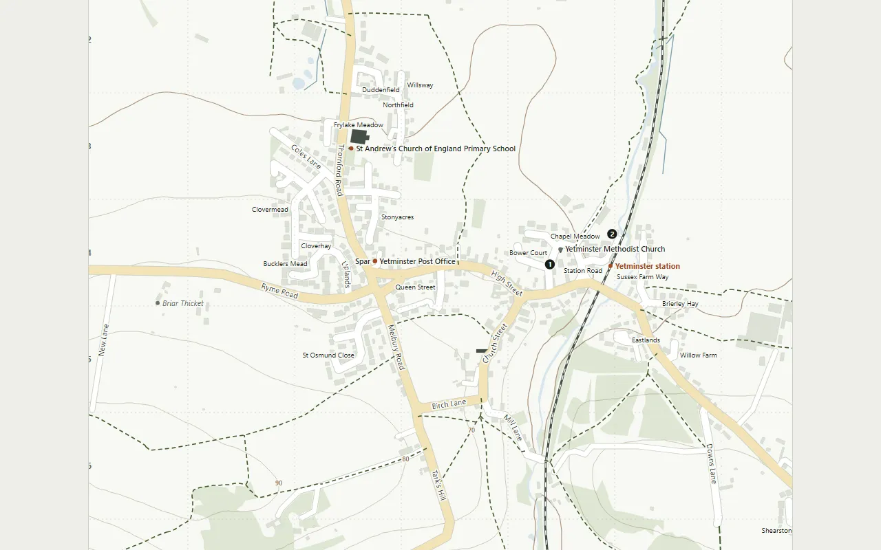 Part of the Yetminster street map: the village's roads and buildings, the railway and station, the church, school and post office, footpaths as dashed lines and contour lines across the fields